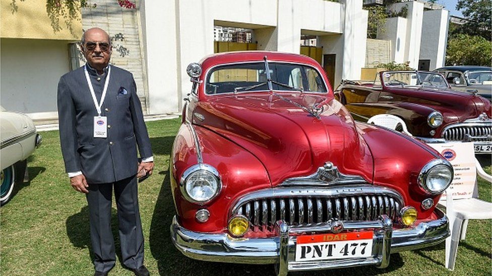 Maharaja Bhagirath Singh of Idar poses next to his USA's 1948 Buick Eight Super car during an exhibition of vintage cars and bikes organised by Gujarat Vintage and Classic Car Club (GVCCC) in Ahmedabad on February 8, 2020.