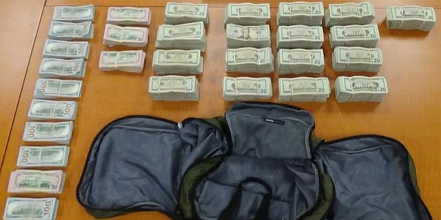 Money laid out on table from drug bust