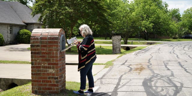 Woman steps out to get her mail