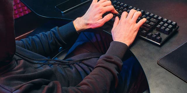 Man typing on his keyboard.