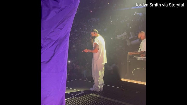 Fan throws a cell phone at Drake while he performs on stage