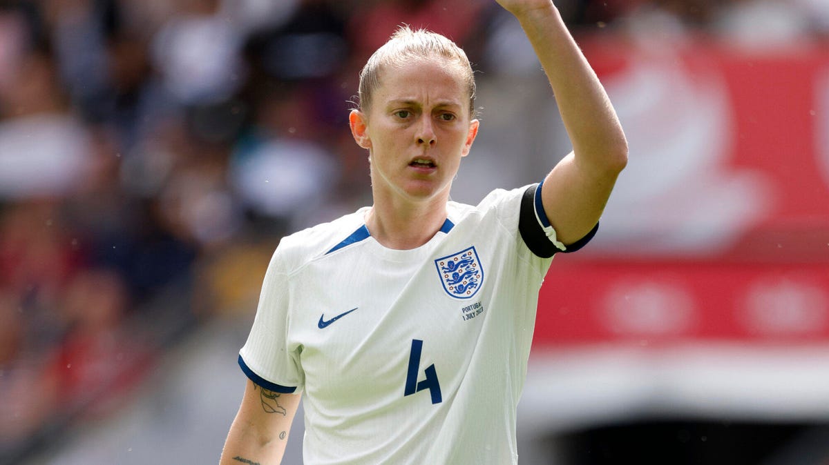 England midfielder Keira Walsh signalling with her left hand aloft.
