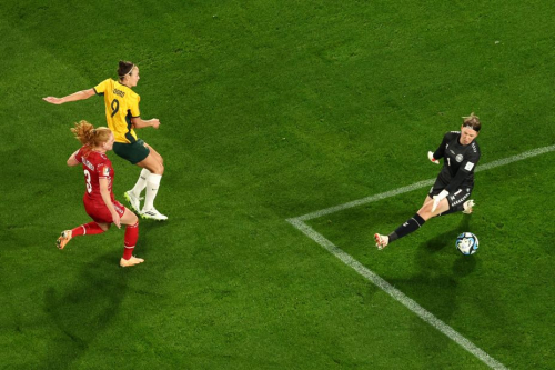 Foord scores a goal past Denmark goalkeeper Lene Christensen.