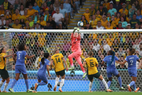 French goalkeeper Pauline Peyraud-Magnin punches the ball away during the quarterfinal match against Australia.