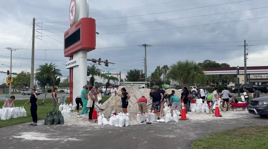 Florida residents shoveling piles of sand into bags as Idalia draws near