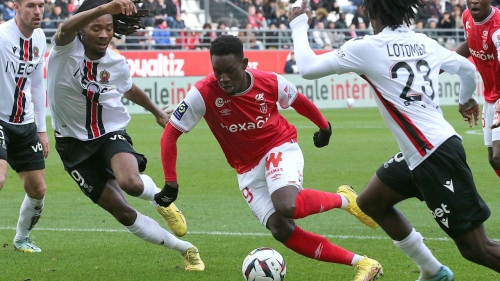 Nice's French midfielder Khephren Thuram (2ndL) fights for the ball with Reims' English forward Folarin Balogun next to Nice's Swiss defender Jordan Lotomba during the French L1 football match between Stade de Reims and OGC Nice at Stade Auguste-Delaune in Reims, northern France on January 15, 2023. (Photo by FRANCOIS NASCIMBENI / AFP) (Photo by FRANCOIS NASCIMBENI/AFP via Getty Images)