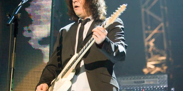 Andy Taylor plays guitar during Duran Duran concert