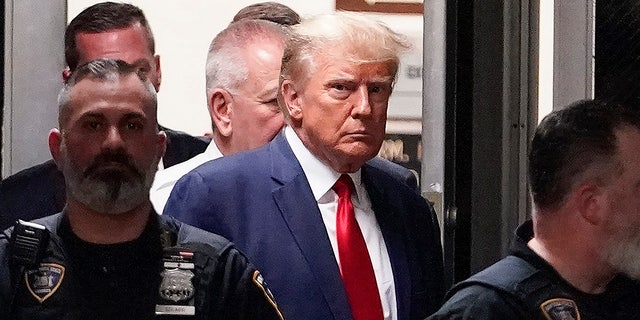 Trump enters NY courtroom surrounded by police