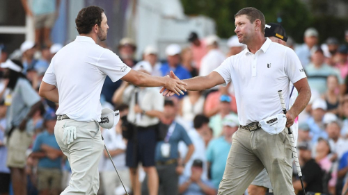 Aug 13, 2023; Memphis, Tennessee, USA; Patrick Cantlay shakes hands with Lucas Glover (right) after Glover won the tournament following a one hole playoff during the final round of the FedEx St. Jude Championship golf tournament. Mandatory Credit: Christopher Hanewinckel-USA TODAY Sports