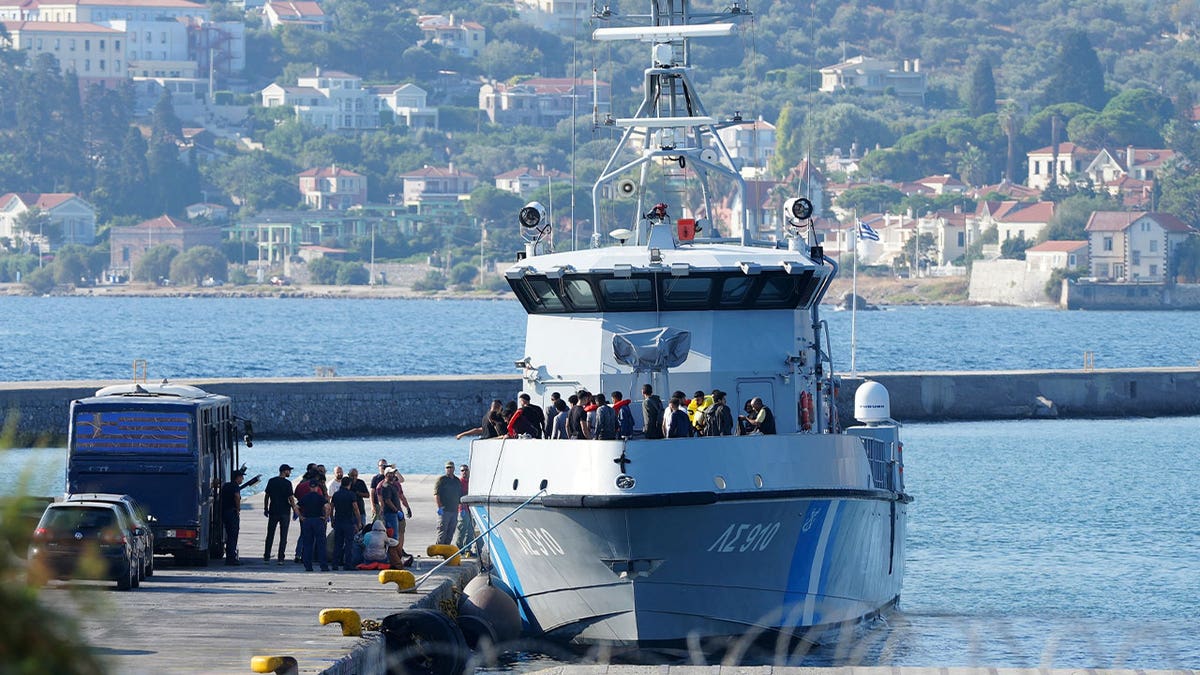 greek coast guard carrying migrants