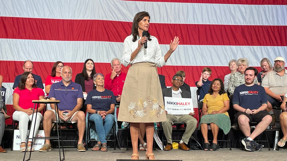 Nikki Haley in front of supporters, US flag on stage
