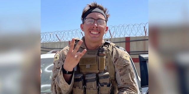 Merola poses in Marine fatigues