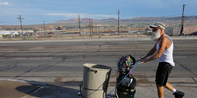 Homeless man shown walking through an arid desert in San Bernardino County 