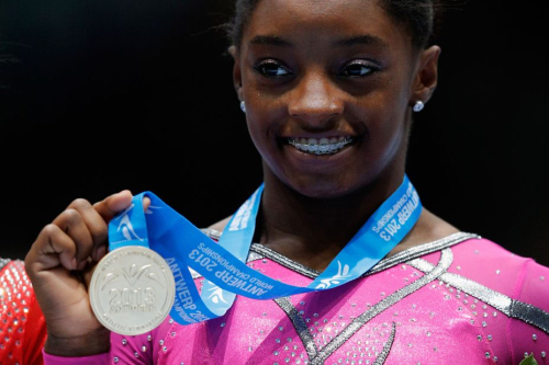 Biles poses after winning a gold medal at the 2013 World Championships. She finished first in the individual all-around.