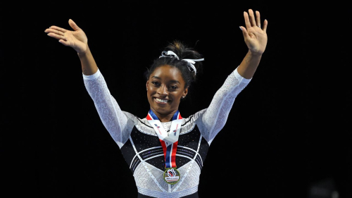 Simone Biles celebrates after winning the all-around competition at the Core Hydration Classic.