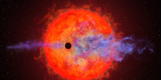 An illustration of a planet passing in front of the red dwarf star AU Microscopii