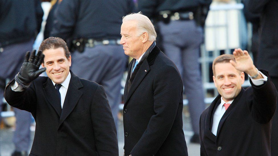 Hunter (left), with father Joe and brother Beau, waves at supporters during Barack Obama's inauguration as president