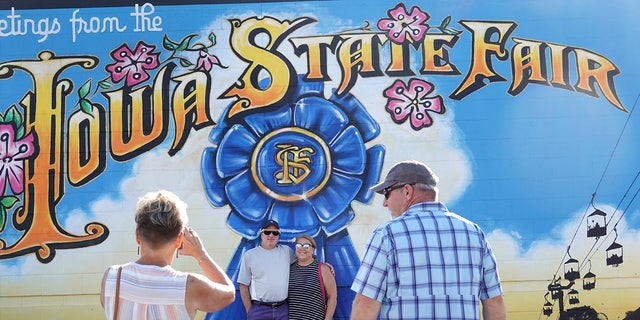People take photos with the Iowa State Fair sign