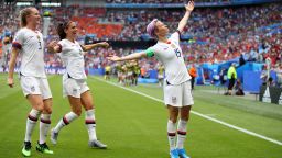 Megan Rapinoe of the USA celebrates with teammates Alex Morgan and Samantha Mewis after scoring her team's first goal during the 2019 FIFA Women's World Cup France Final match between The United States of America and The Netherlands at Stade de Lyon on July 7, 2019 in Lyon, France.