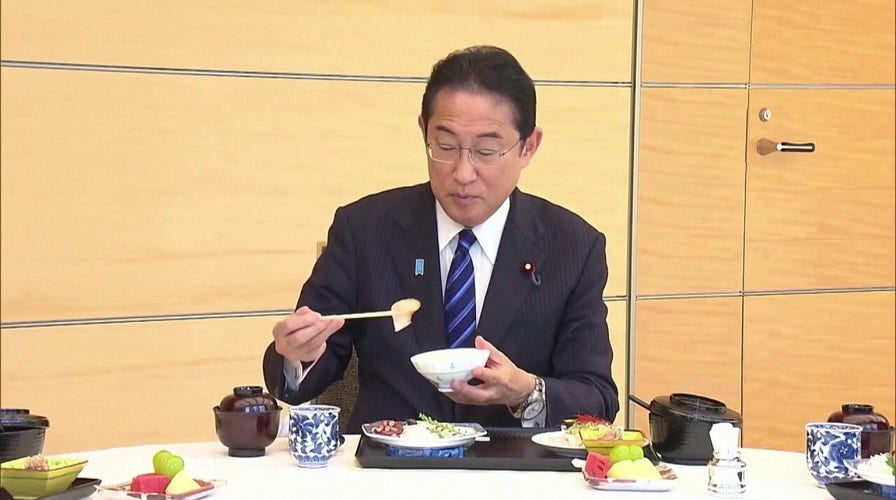 Japanese prime minister tastes fish to prove safety after radioactive plant dump