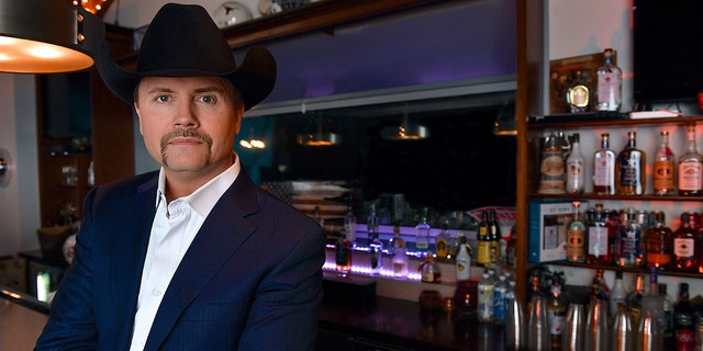 Country singer John Rich wears black cowboy hat at bar