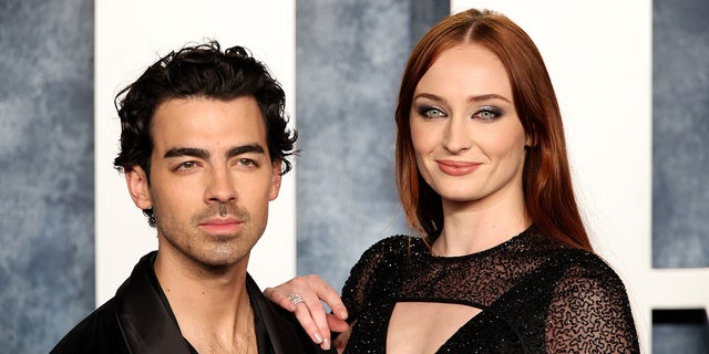 Joe Jonas in black and Sophie Turner in a sparkly lace black dress on the carpet at the Vanity Fair Oscar party