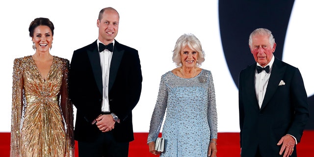 Kate Middleton in a sparkling gold dress standing next to Prince William in a tux, Queen Camilla in a sky blue dress and King Charles III in a tux