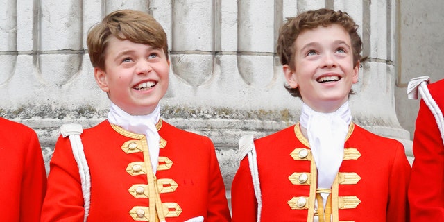 Prince George and Lord Oliver in matching red and gold coats
