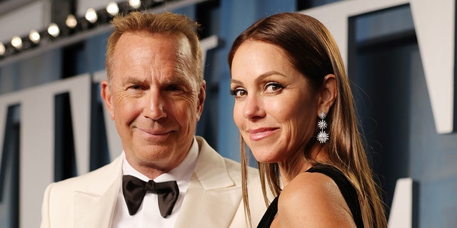 Kevin Costner wears white suit to Oscars after party with Christine Baumgartner