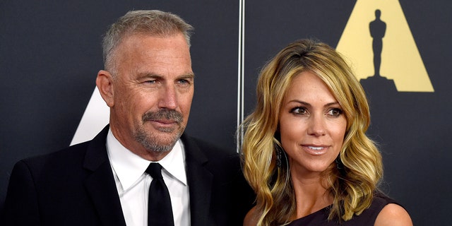 Kevin Costner and Christine Baumgartner at the Academy Awards in 2014