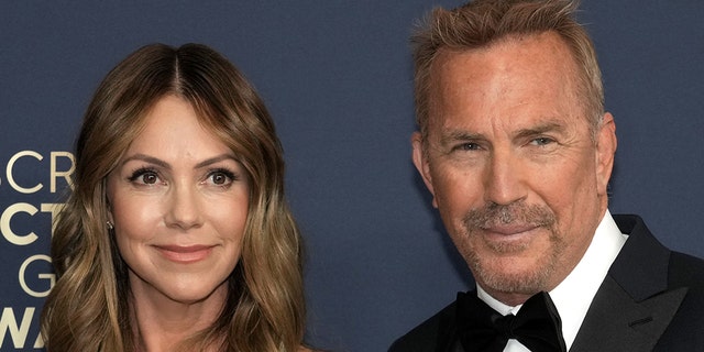 Kevin Costner and Christine Baumgartner walk red carpet