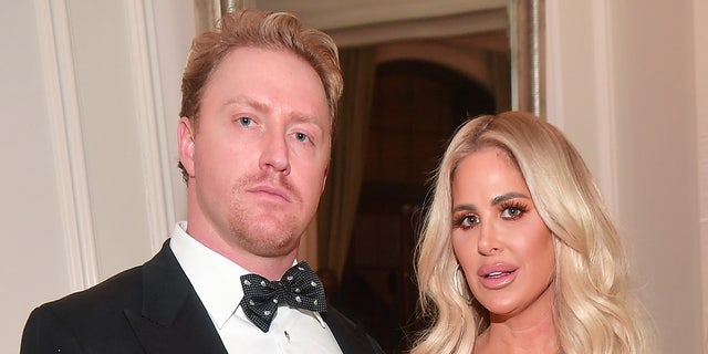 Kroy Biermann wears a tuxedo with bow-tie alongside estranged wife Kim Zolciak at event