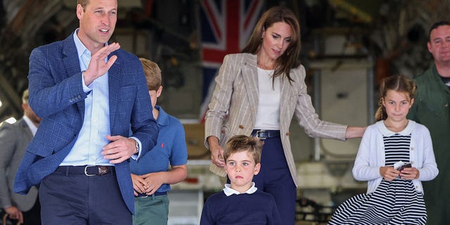 Prince William and Kate Middleton with their kids on a large aircraft