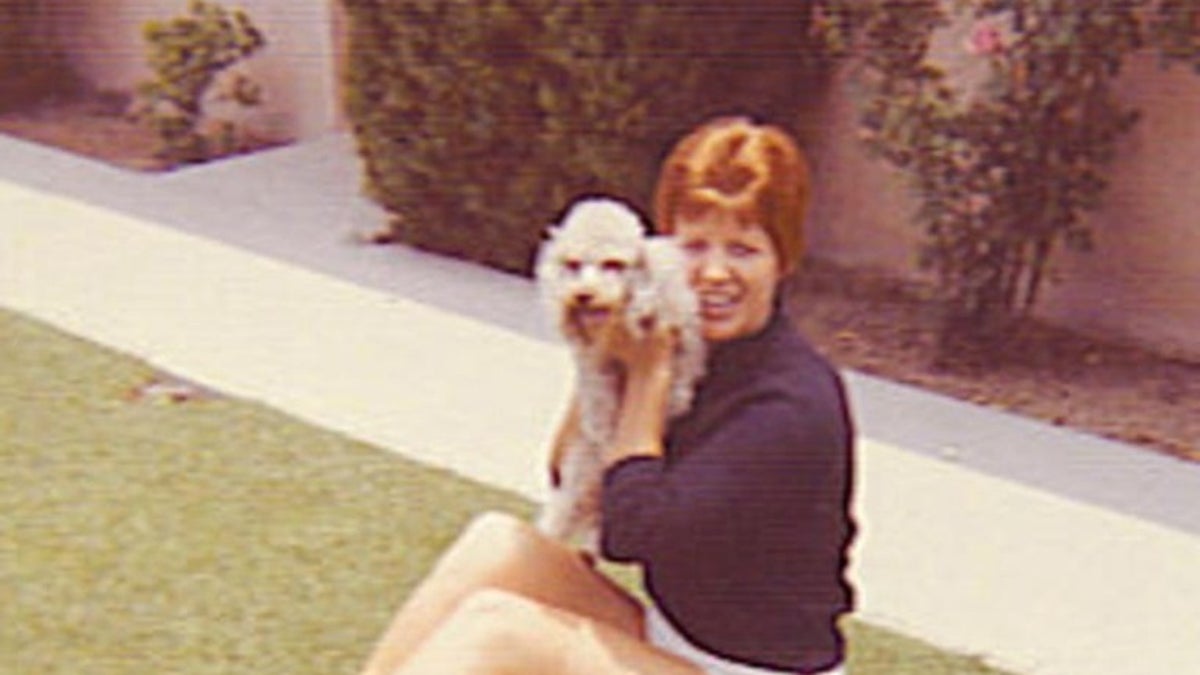 Photo shows Ruth MArie terry posing with dog
