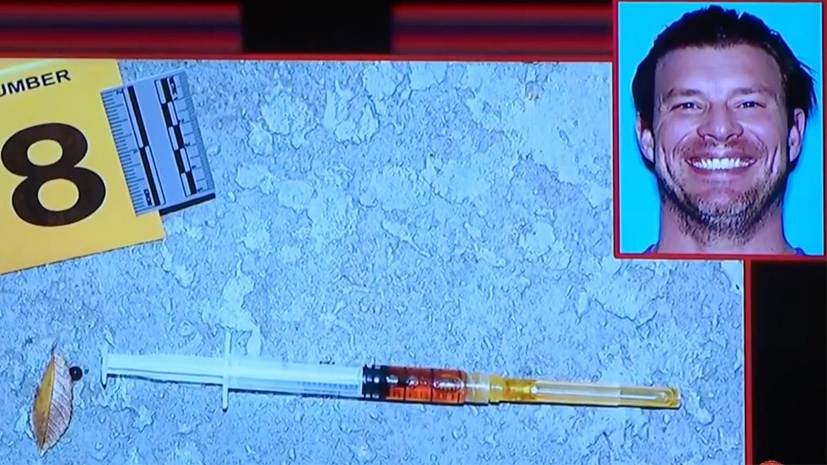 Evidence photo of a syringe filled with brown liquid
