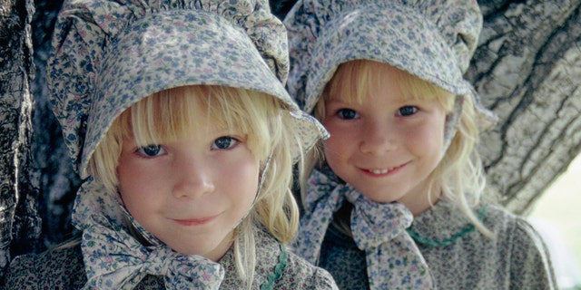 A close-up of Wendi Lou Lee and her twin sister in costume as baby grace ingalls