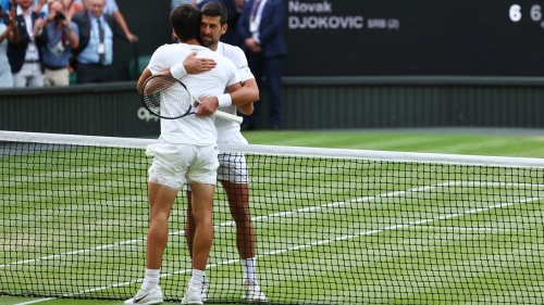 Carlos Alcaraz and Novak Djokovic embrace after the Wimbledon final.