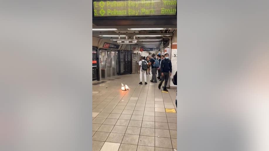 subway riders and flaming newspaper