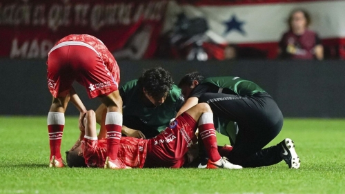 Luciano Sanchez of Argentina's Argentinos Juniors receives medical treatment after he snapped his knee during a play with Marcelo of Brazil's Fluminense in a Copa Libertadores round of 16 first leg soccer match at Diego Armando Maradona stadium in Buenos Aires, Argentina, Tuesday, Aug. 1, 2023. (AP Photo/Ivan Fernandez)