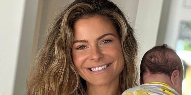 maria menounos smiling and holding her baby daughter