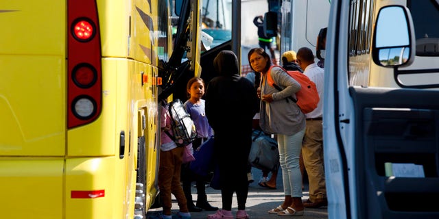 Venezuelan migrants board buss at Marthas Vineyard, Massachusetts.