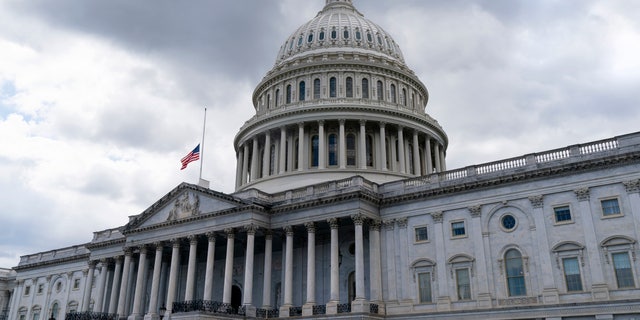 The American flag flies at half-staff over the U.S. Capitol