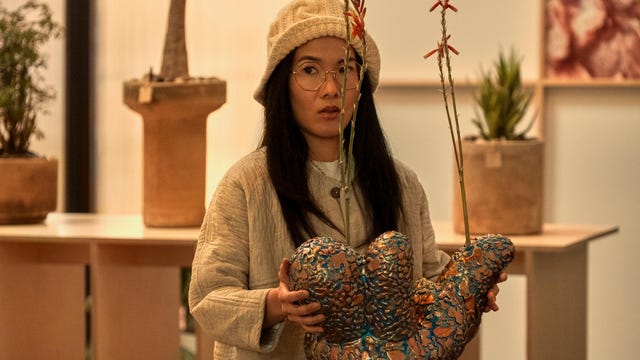 Ali Wong wears a hat and holds a sculpture in Beef scene