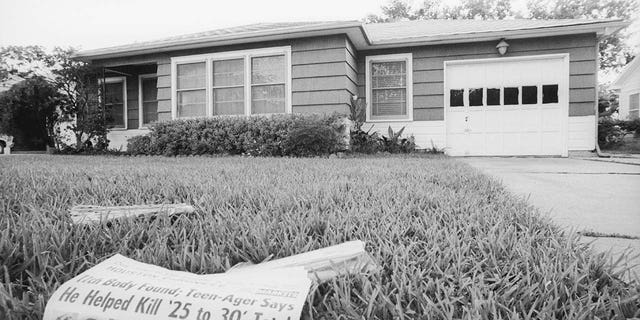 A newspaper sits in the front lawn of a house