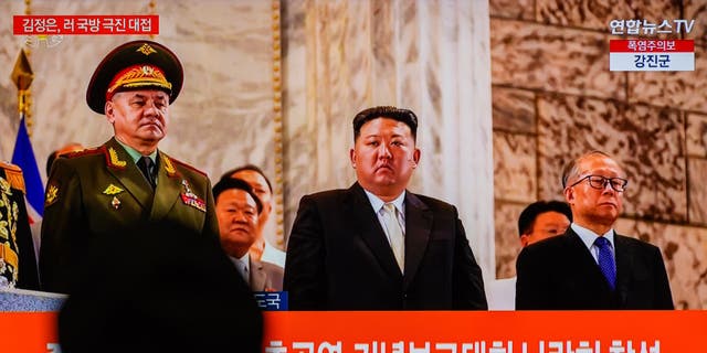 Kim Jong un watches military parade
