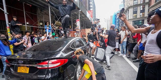Rioter atop car in Union Square, New York City