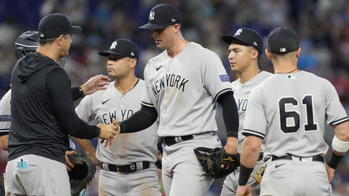 New York Yankees manager Aaron Boone relieves pitcher Clay Holmes during the ninth inning of a baseball game against the Miami Marlins, Sunday, Aug. 13, 2023, in Miami. (AP Photo/Marta Lavandier)