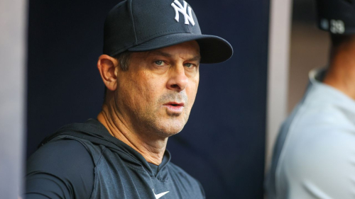 New York Yankees manager Aaron Boone (17) in the dugout before a game against the Atlanta Braves at Truist Park on August 16, 2023.