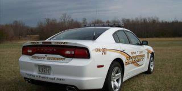 white sheriff's patrol car in field