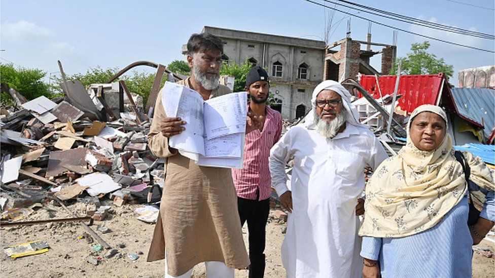 bdul Rashid showing their property paper outside demolished shops in Nalhar village near Shaheed Hasan Khan Mewati Medical College after District administration started a demolition drive against the illegal construction in Nuh after the communal violence on August 7, 2023 in Mewat, India.